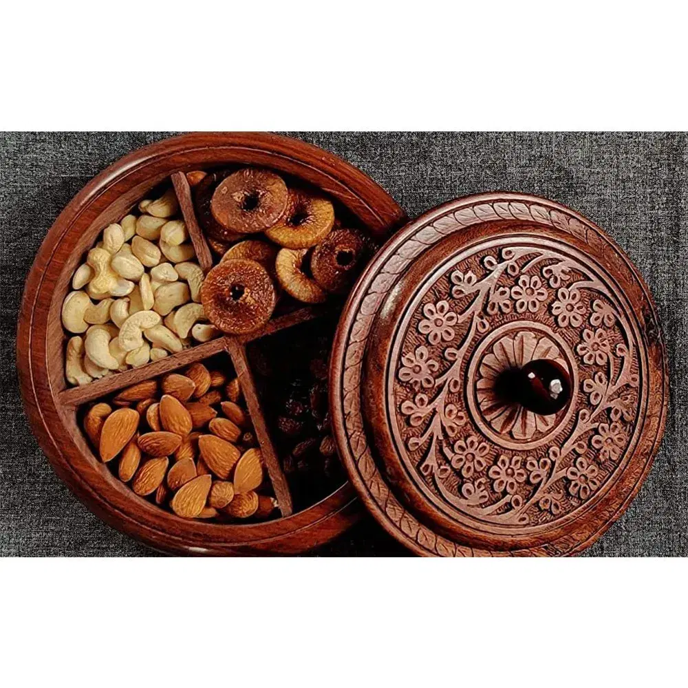 Round carved wooden dry fruit box filled with nuts